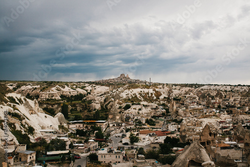 Top view. A small authentic city called Goreme in Cappadocia in Turkey in the evening. Dramatic night sky.