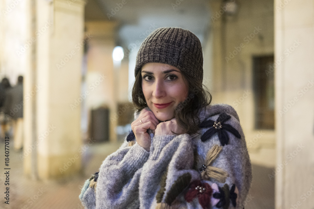 Beauty woman in night scene with wool cap looking at camera. Winter clothing Beauty woman in night scene with wool cap looking at camera. Winter clothing