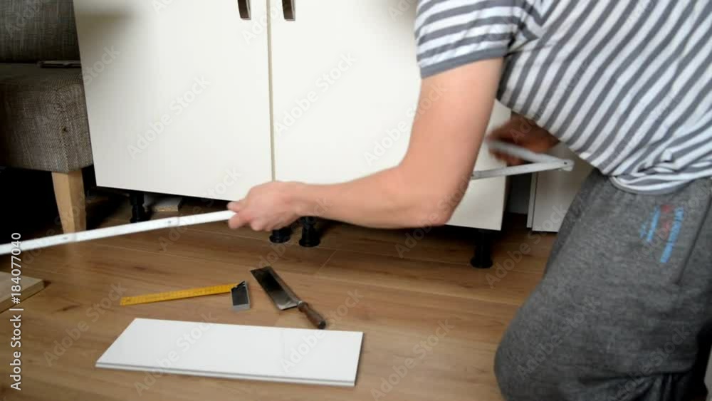 man inserts a board in the kitchen man inserts a board in the kitchen