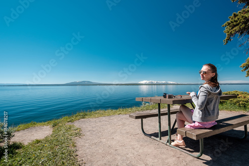 Wallpaper Mural Woman tourist having a breakfast by Yellowstone Lake Torontodigital.ca