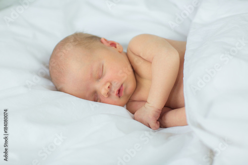 The newborn sleeps. Age 10 days.