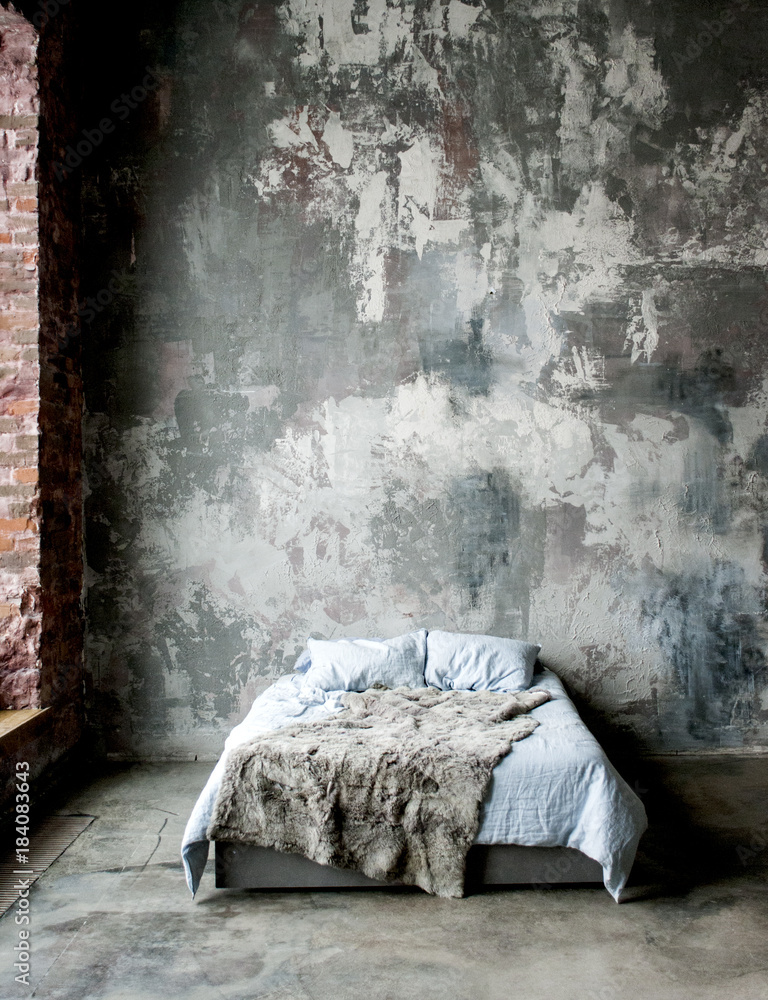 bedroom interior with a textured wall in gray tones