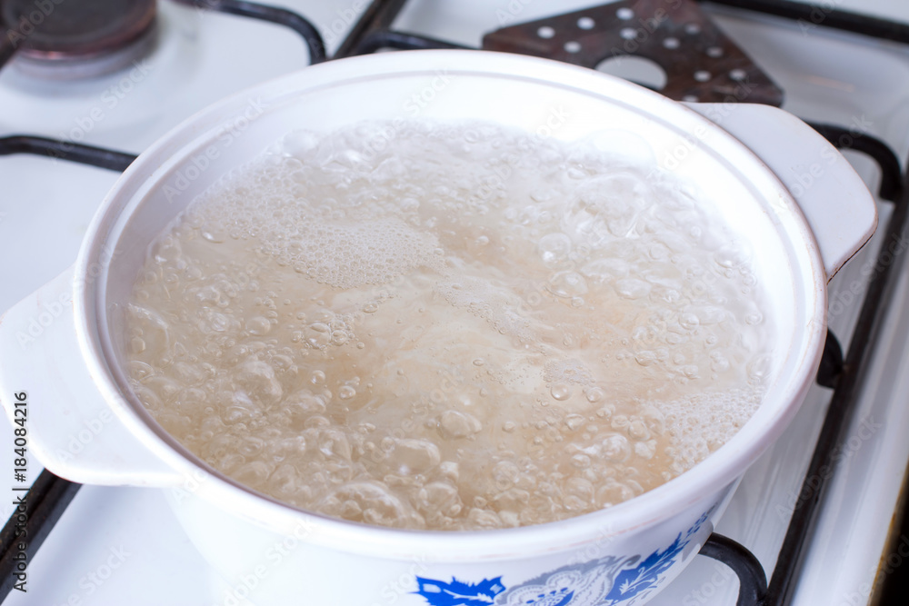Boiling water in pan in kitchen Boiling water in pan in kitchen