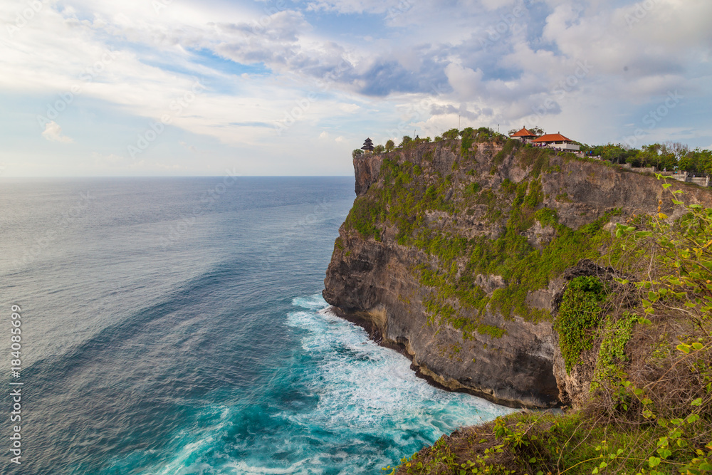 Beautiful view of Uluwatu temple and ocean rocky cliff. Scenic landscape of fantastic view. Bali, Indonesia.