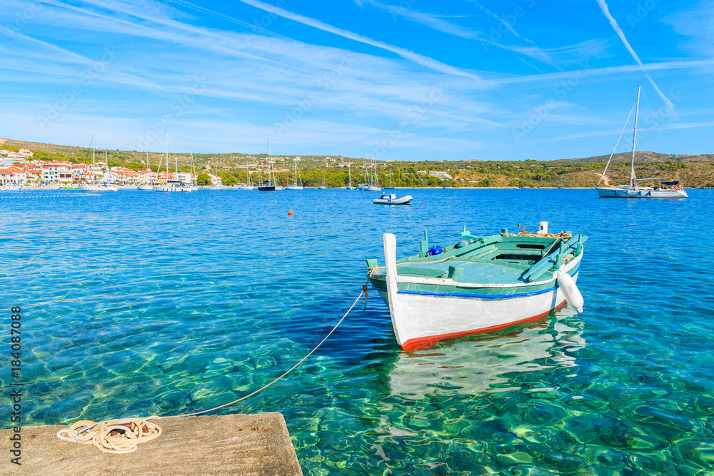 Fishing boat mooring on sea shore in Primosten town, Dalmatia, Croatia