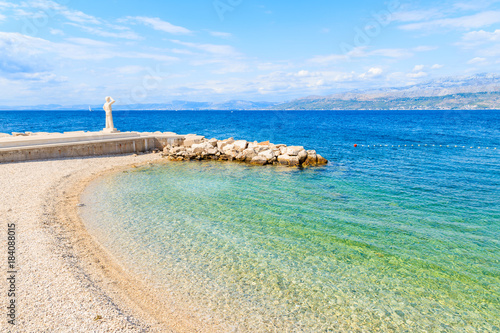 View of beach with turquoise sea water in Postira village, Brac island, Croatia