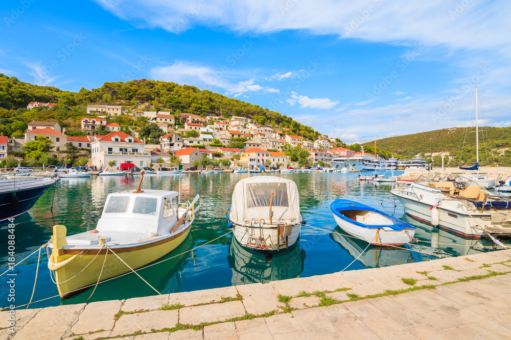 Fishing boats mooring in picturesque Pucisca port, Brac island, Croatia