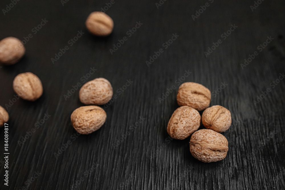 Lots of fresh nuts on a black wooden background. Best practices for designer Lots of fresh nuts on a black wooden background. Best practices for designer
