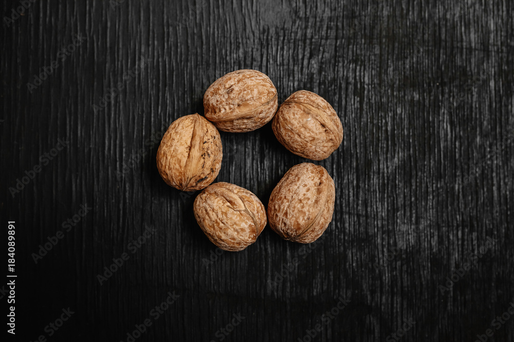 Lots of fresh nuts on a black wooden background. Best practices for designer. A beautiful design from the nuts