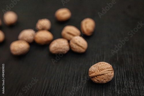 Lots of fresh nuts on a black wooden background. Best practices for designer