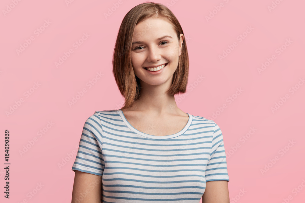 Attractive female model with stylish hairdo, has healthy skin, dark shining eyes and pleasant smile, expresses positive emotions after having date with handsome male, glad to find true love. Attractive female model with stylish hairdo, has healthy skin, dark shining eyes and pleasant smile, expresses positive emotions after having date with handsome male, glad to find true love.