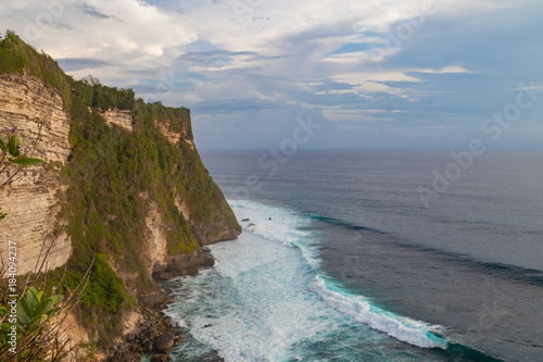 Beautiful view of ocean rocky cliff near Uluwatu temple on sunset. Scenic landscape of fantastic view. Bali, Indonesia.