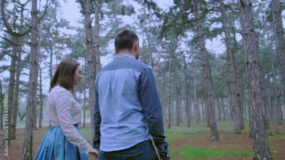 Young couple guy and girl are walking in the autumn park Young couple guy and girl are walking in the autumn park