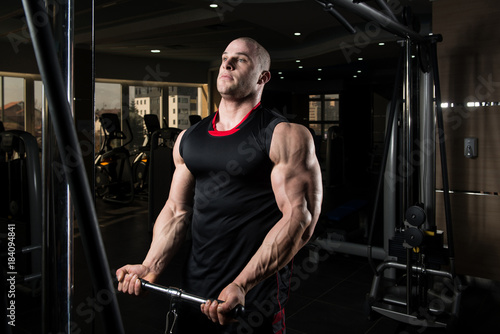 Man Exercising Biceps In The Gym