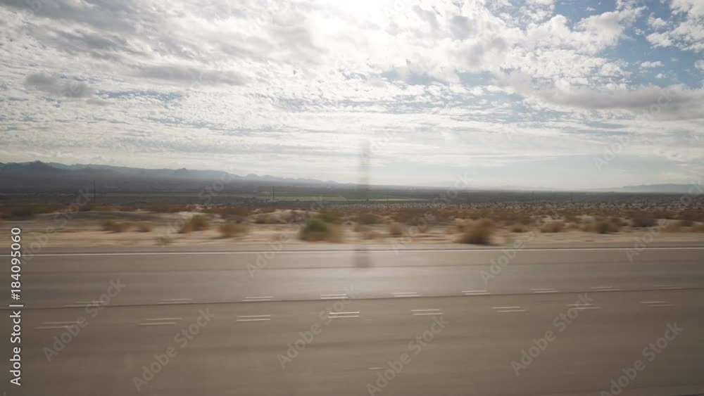 Driving plate side view moving through desert in car Driving plate side view moving through desert in car