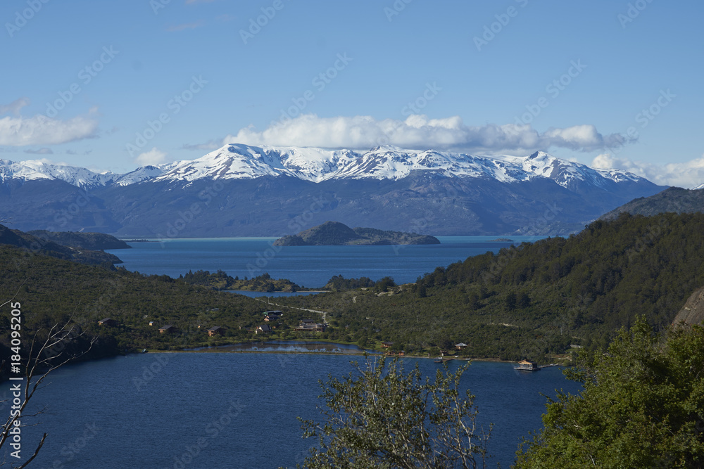 Obraz premium Landscape along the Carretera Austral next to the azure blue waters of Lago General Carrera in Patagonia, Chile. Lago Bertrand in the foreground. 