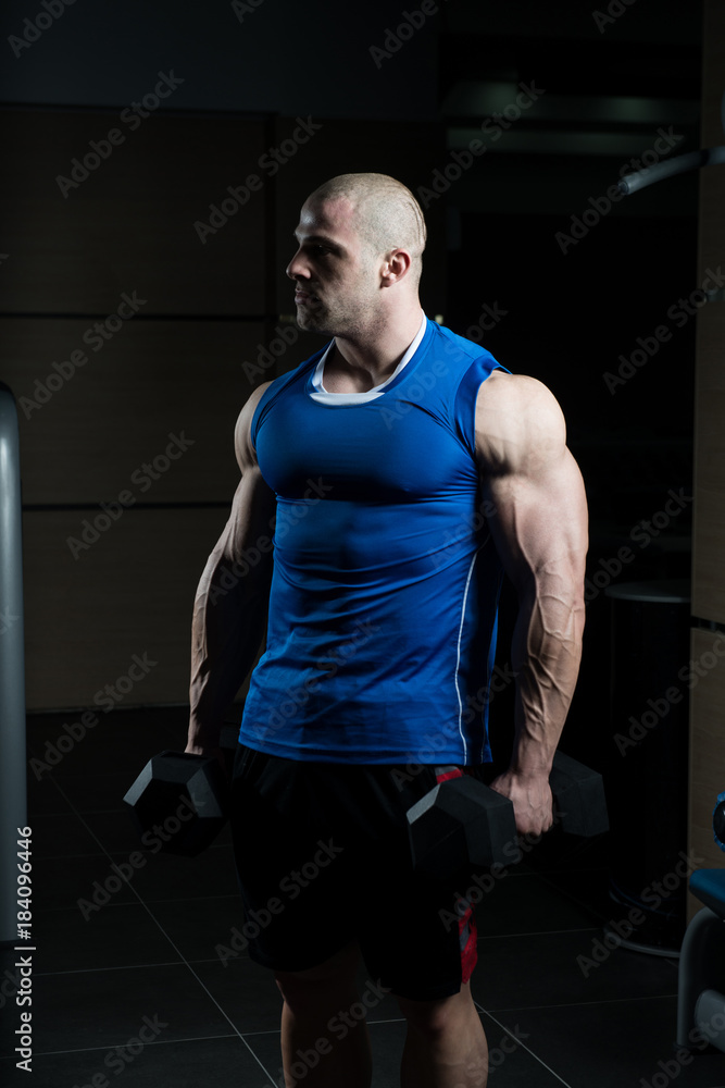 Man With Dumbbells Exercising Biceps
