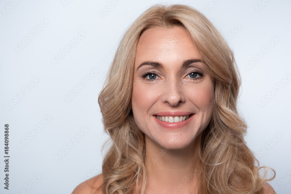 Full of joy. Close-up portrait of cheerful elegant adult naked lady is standing and looking at camera with smile. Isolated background. Copy space Full of joy. Close-up portrait of cheerful elegant adult naked lady is standing and looking at camera with smile. Isolated background. Copy space