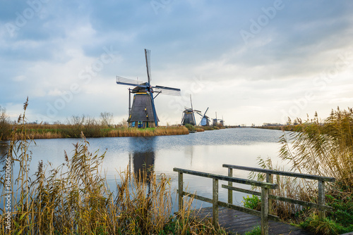 Old windmills in Kinderdijk at sunrise, Holland, Netherlands, Europe. Unesco world heritage site. © icephotography