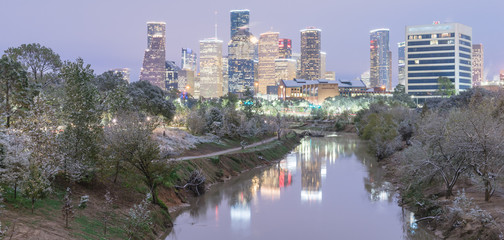 Panorama view unusual snowfall along Bayou River bank with downtown Houston, Texas, USA skylines city lights reflection at sunrise/twilight. Snow is extremely rarely and happen only 35 time since 1895