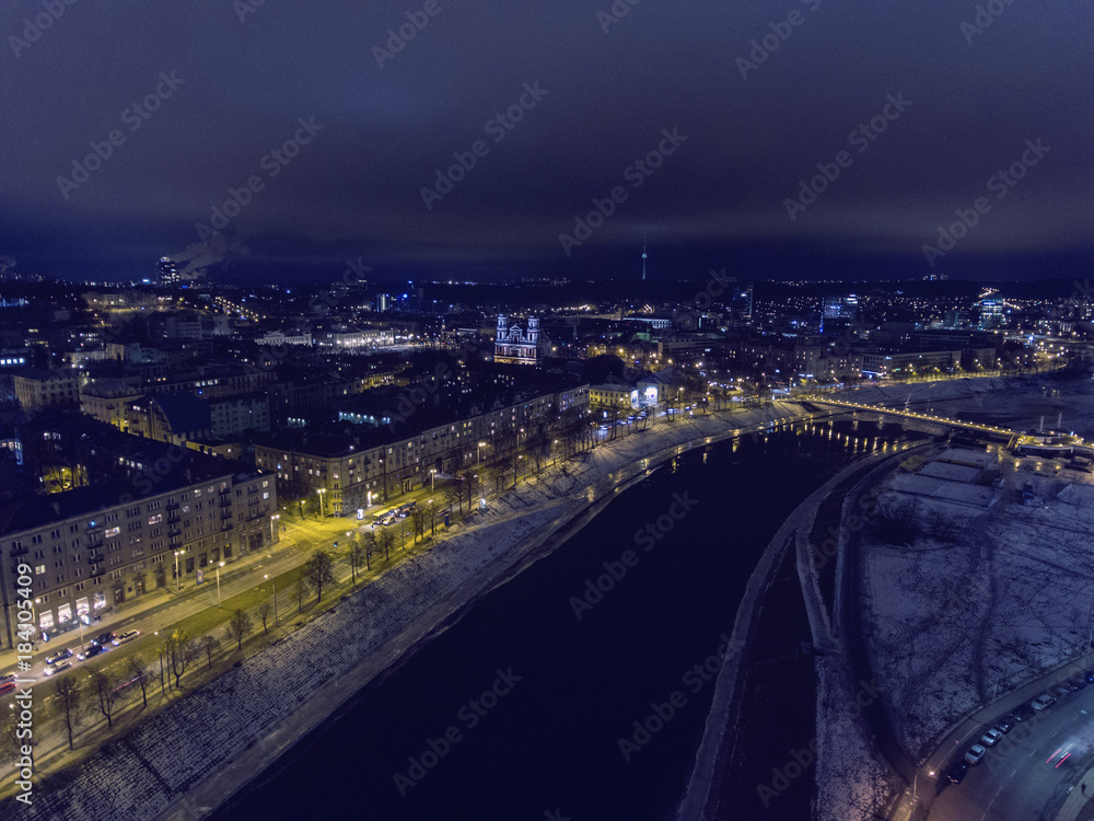 Fototapeta premium Aerial view over busy Vilnius the capital city of Lithuania, during winter season night time.