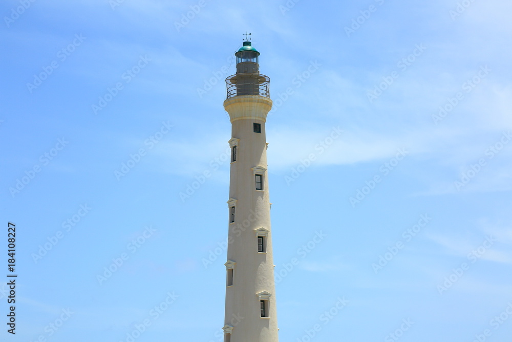 California Lighthouse on blue sky background isolated, Aruba coastline. Nice background.