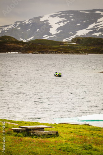 People canoeing in lake photo