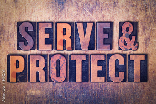 Serve & Protect Theme Letterpress Word on Wood Background