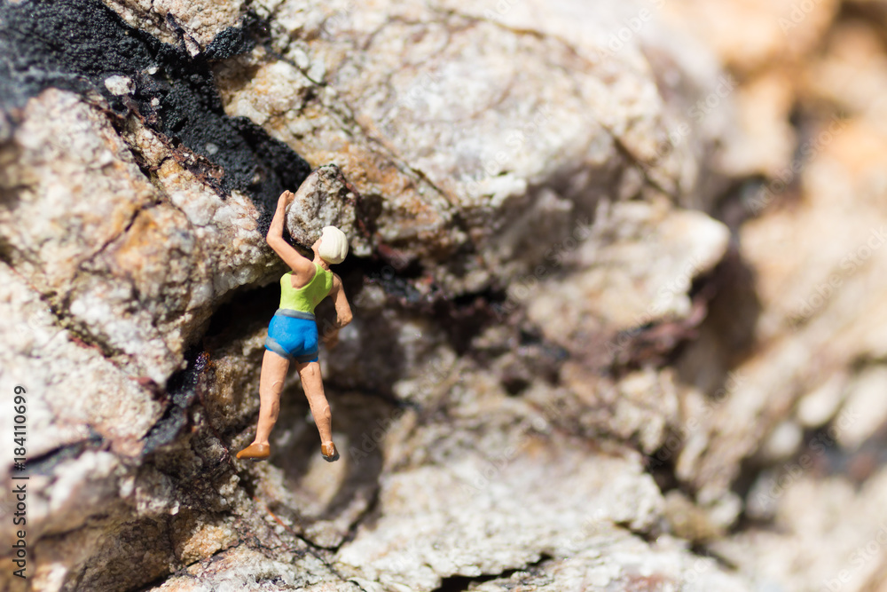Miniature people : Women are playing high climbing sport. Used as a background for holiday adventure travel business concept.