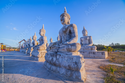 a lot of Buddha statues have many sizes are arranged in a row in the large yard of the place of religious activities.