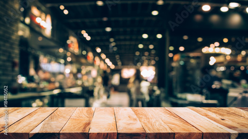 Wood table top (Bar) with blur light bokeh in dark night cafe,restaurant background