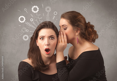 фотографія girl telling secret things to her girlfriend