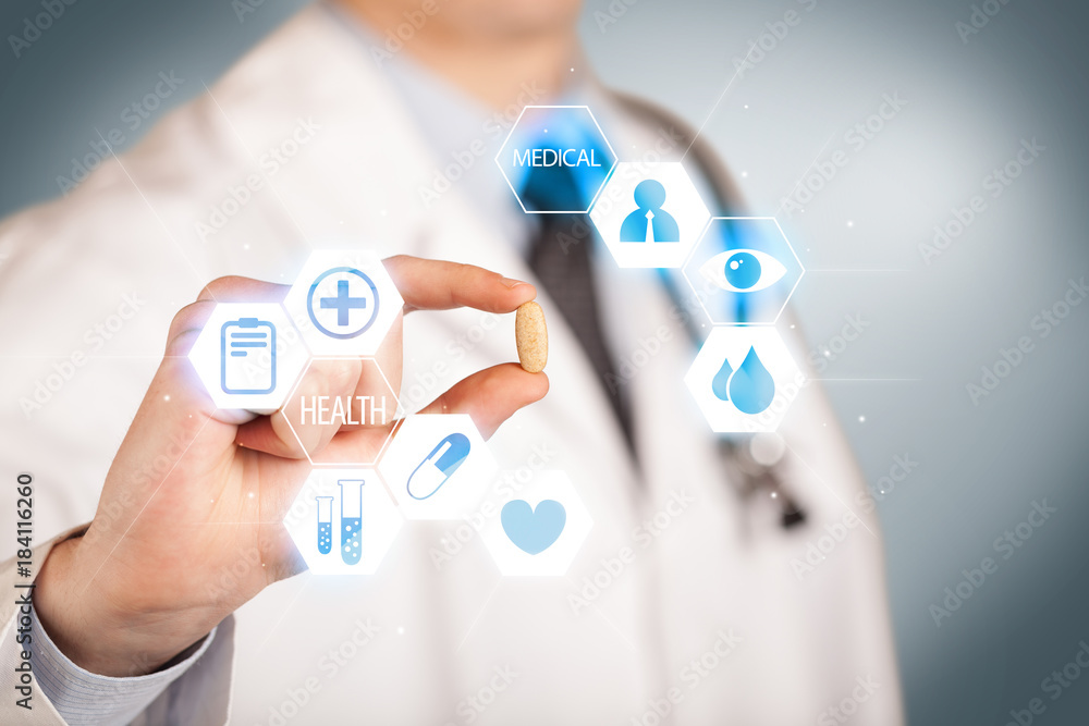 A doctor in white holding a pill A doctor in white holding a pill