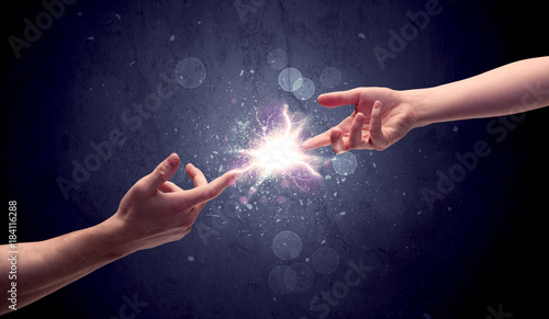 Hands reaching to light a spark © ra2 studio