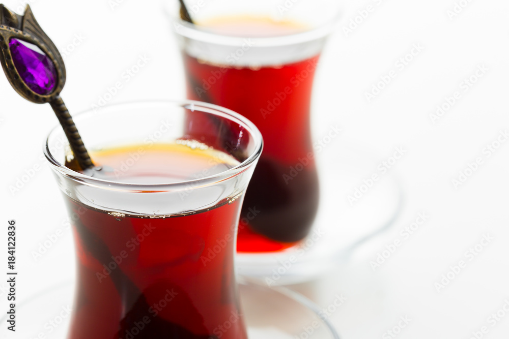 Turkish tea in traditional glass isolated on white background Turkish tea in traditional glass isolated on white background