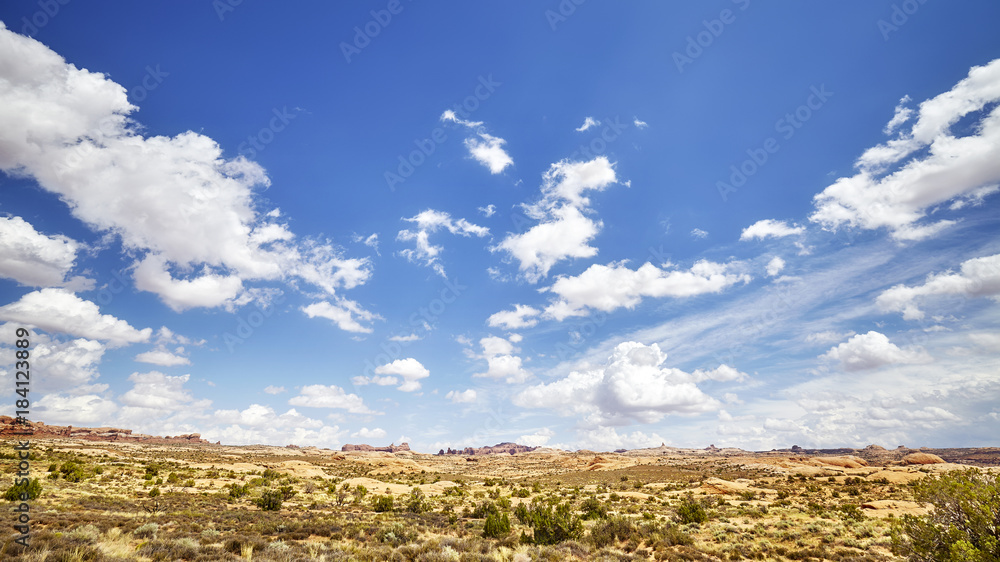 Vast deserted landscape with beautiful cloudscape on the blue sky. Vast deserted landscape with beautiful cloudscape on the blue sky.