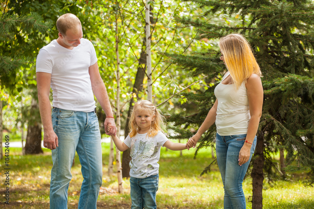Fototapeta premium stylish young family in the same clothes for a walk