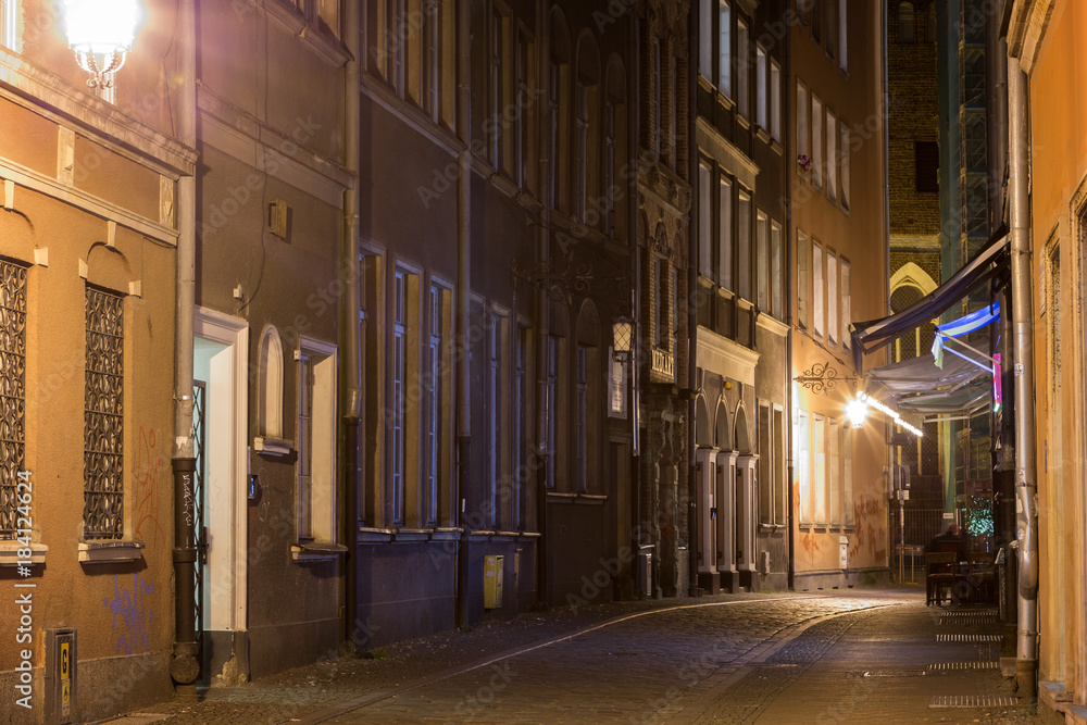 View of the lit Kaletnicza Street and St. Mary's Church at the Main Town (Old Town) in Gdansk, Poland, in the evening. View of the lit Kaletnicza Street and St. Mary's Church at the Main Town (Old Town) in Gdansk, Poland, in the evening.