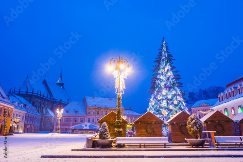 Beautiful Christmas scene in medieval town of Transylvania Brasov  with tree and decorations in main center square