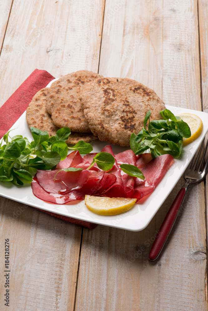 integral flat bread with bresola and salad integral flat bread with bresola and salad