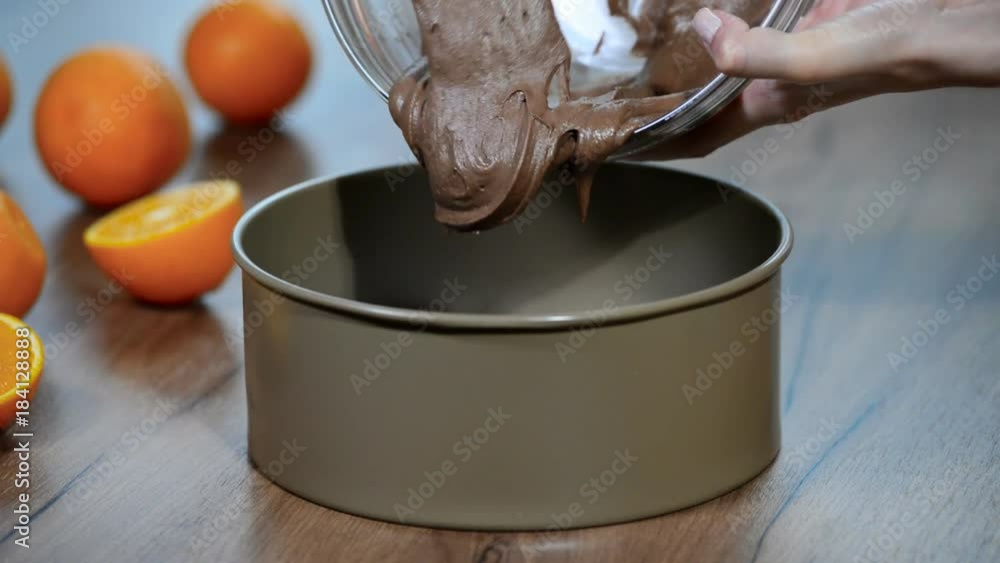 Pouring cake mix into baking tin Pouring cake mix into baking tin