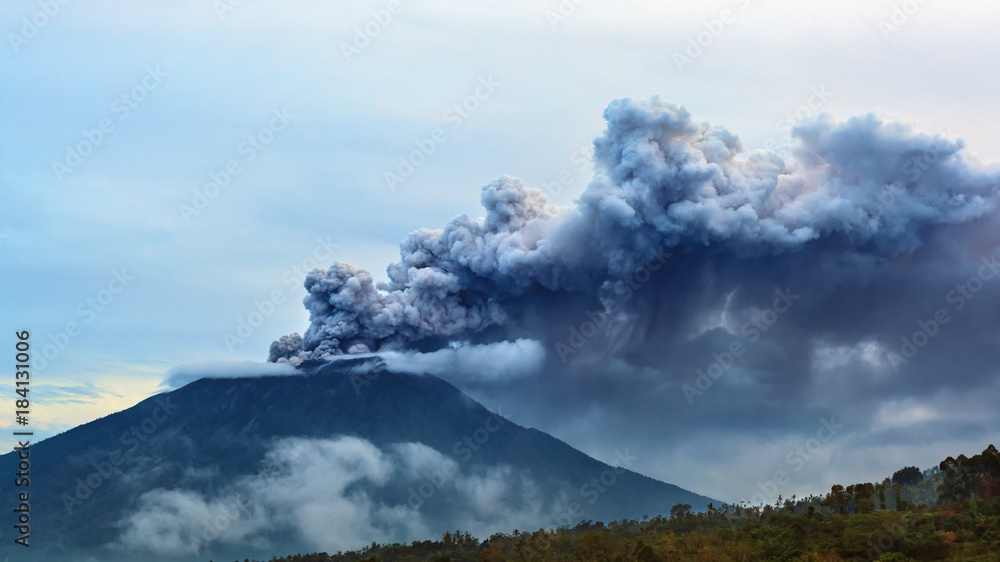 Mount Agung erupting plume. During volcano eruption thousands of people was evacuated from dangerous zone. Airline flights to Bali were canceled, Denpasar airport closed because of volcanic ash clouds
