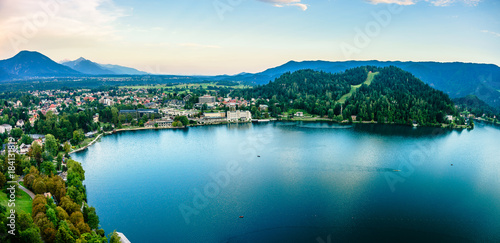 Evening views on the lake Bled with the famous Pilgrimage Church of the Assumption of Maria and Bled Castle and Julian Alps at background