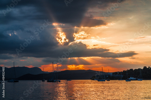 Colorful sunset in Poros island port with the sailing boatsin Greece