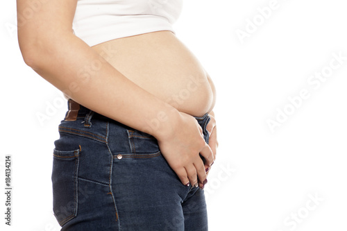 the woman shows her stomach that has risen from overeating © vladimirfloyd