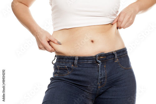 woman pinches her fat on her belly