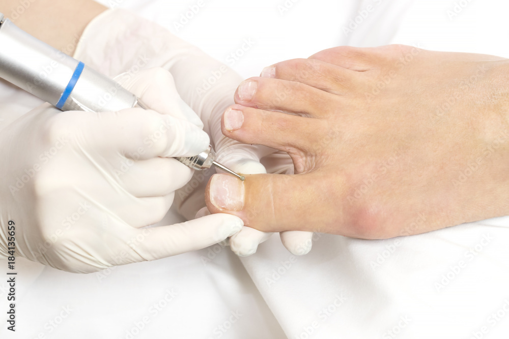 Female foot in the process of pedicure procedure in a beauty salon close-up. Female foot in the process of pedicure procedure in a beauty salon close-up.