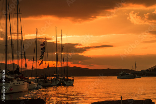 Fototapeta Naklejka Na Ścianę i Meble -  Sailing boats at sunset in Poros island in Greece