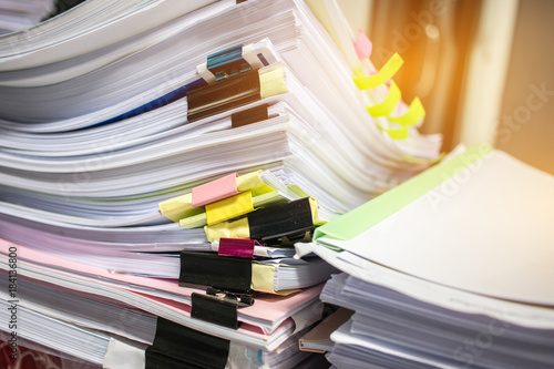 Paper stack, Pile of unfinished documents on office desk related to business functions. Stack of business papers for Annual Report files, Document is written,drawn,presented. Business offices concept. photo