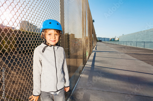 Sporty kid practicing at outdoor rollerdrom photo